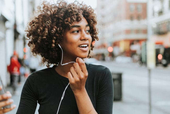 Cheerful woman talking through a headset